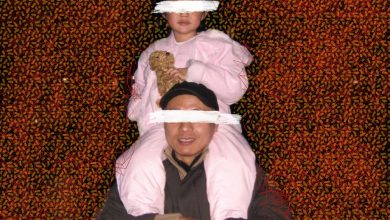 At the center of the image, a young Asian girl holding a teddy bear sits atop a man’s shoulders  — their eyes are blocked out with white paint strokes. The background is made up of opaque yellow docs and overlapping red geometric shapes.