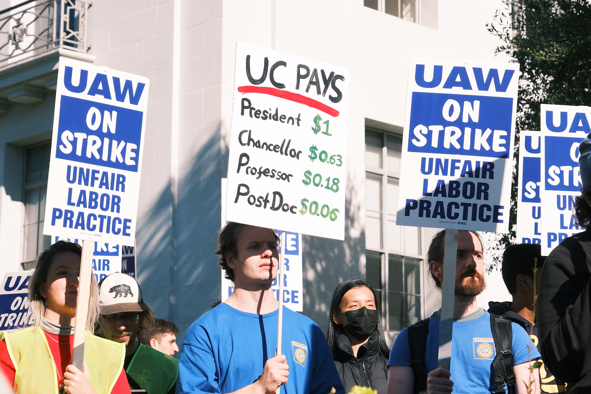 A group of striking workers carrying UAW signs.